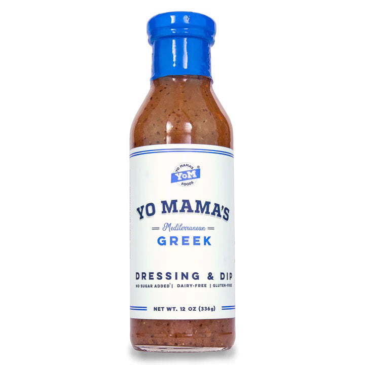 A 12 oz bottle of YO MAMA'S - MEDITERRANEAN GREEK DRESSING from YO MAMA'S FOODS features a blue cap and a white label with blue text, emphasizing that the product is vegan, has no sugar added, is dairy-free, and gluten-free.