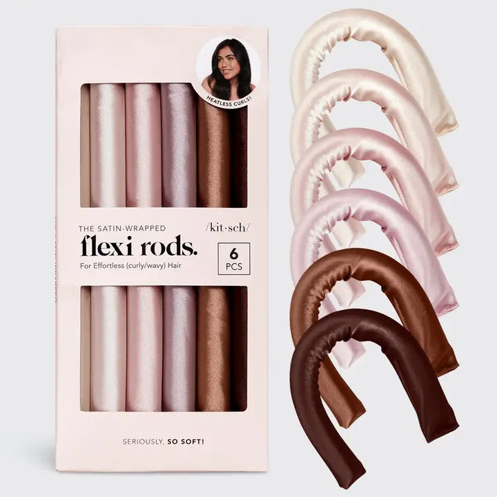 Six satin-wrapped flexi rods from KITSCH are displayed on a light background in brown and pink, with some coiled and others straight—ideal for achieving effortless, heatless curls using this vegan hair roller set.