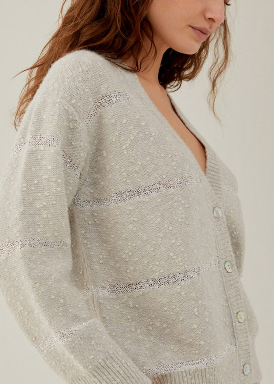 Close-up image of the ANNECLAIRE - PAILETTES STRIPE CARDIGAN by ANNECLAIRE, showcasing its textured knit with a rough, bubbly surface in fun mixtures of dark and light shades, and various circular embellishments.