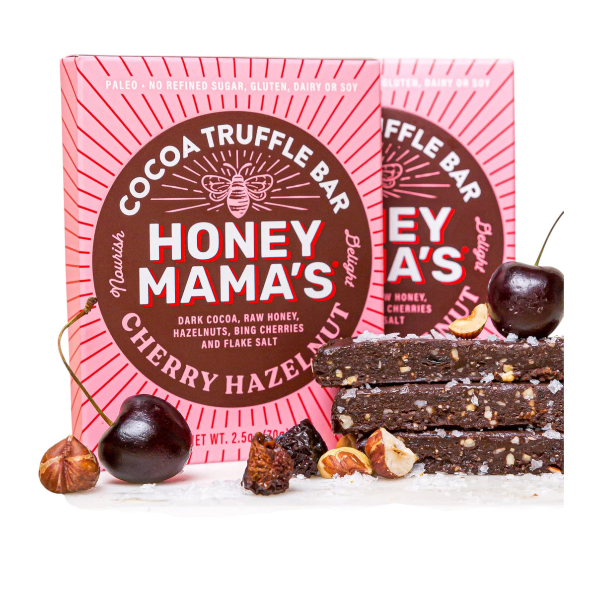 The HONEY MAMA&#39;S CHERRY HAZELNUT TRUFFLE BAR, a limited edition from HONEY MAMA&#39;S, features dark cocoa, raw honey, toasted hazelnuts, bing cherries, and flake salt in pink and brown packaging.