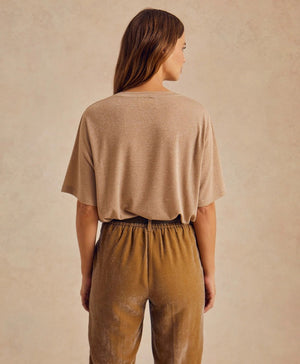 The MOMONI - IORA LUREX JERSEY T SHIRT by MOMONI is a red, short-sleeve, loose-fitting T-shirt with a subtle shimmer. Crafted from soft lurex jersey, this shirt features a round neckline and is made of a soft, lightweight material. Made in Italy. The background is plain white.