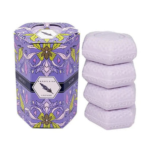 Experience the luxurious lather of BAUDELAIRE’s Lavender Honey Soap Quartet, featuring four 1.4 oz triple-milled soaps nestled in a beautifully designed hexagonal box with a purple floral motif. The front label displays the ingredients and highlights available fragrances, such as wild lavender honey soap, goat milk soap, orange blossom, and calendula. These gentle soaps are suitable for all skin types and provide an indulgent cleansing experience.