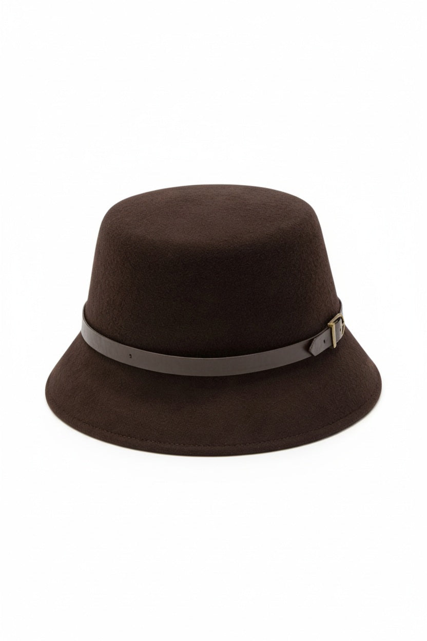 The SEVENTY VENEZIA - CLOCHE HAT by SEVENTY is a dark brown felt hat with a wide brim, accented by a thin taupe leather strap and small metal buckle around the crown, shown against a plain light background.