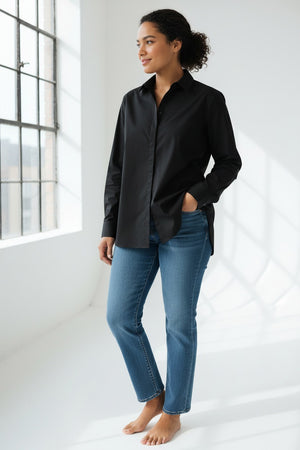 A person with straight brown hair is shown from the back, wearing the HINSON WU SARA Long Sleeve Pleated Back Shirt and black pants, standing against a plain light background.
