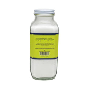 The BAUDELAIRE - BREATHE BATH SELTZER is a handmade 18 oz glass bottle with a yellow/green label, featuring an effervescent formula infused with eucalyptus and all-natural essential oils for a refreshing bath experience.