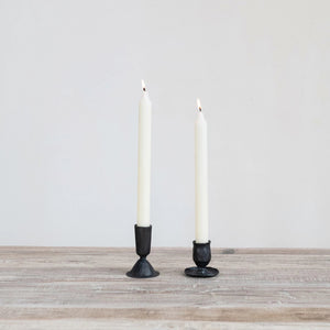 Black, hand-forged CREATIVE COOP HAND FORGED CAST IRON TAPER HOLDER with a hammered finish and a wide, irregular base.