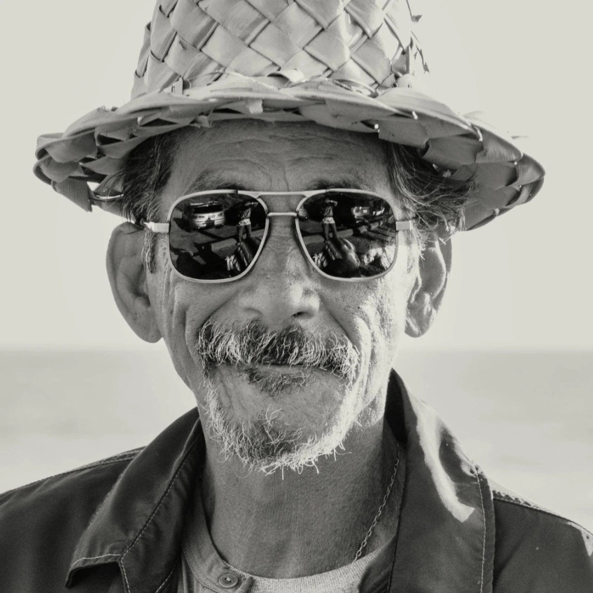 Front view of CADDIS - METAMODERNIST SCOUT SUNGLASSES by CADDIS, featuring an aviator-style sleek metal alloy frame and dark green premium tinted lenses, displayed on a white background.