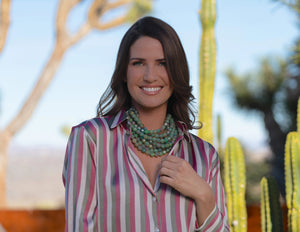 The FAIRCHILD BALDWIN - THE BELLA NECKLACE showcases layered strands of iridescent green Italian resin beads with a faceted design for a shimmering effect, finished with a smooth light green clasp that complements its vibrant hues.