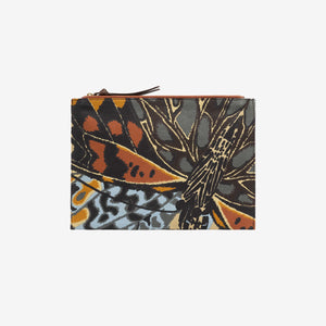 The INOUI EDITIONS - PAPILLON (BUTTERFLIES) POUCH by INOUI is a rectangular pouch with a zippered top, featuring a vibrant abstract butterfly wing print and Italian leather trim, finished with a small brown leather patch on the front.