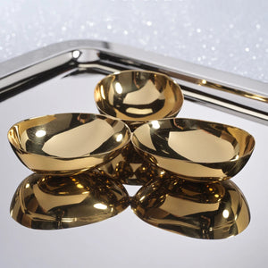 ZODAX TRIPLE NUT BOWL IN POLISHED GOLD featuring three connected 7-inch gold-toned bowls arranged in a cluster.