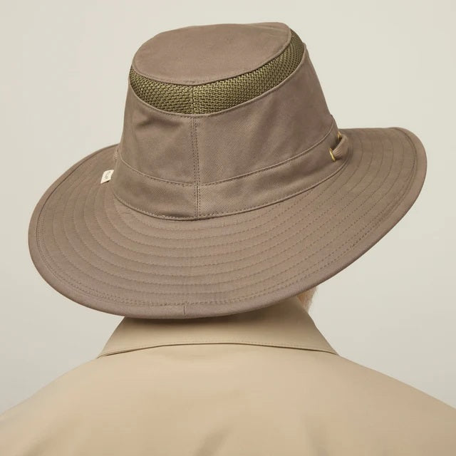 A man with a gray beard and mustache wears the TILLEY Airflo Hikers Hat T4MO-1 in olive, featuring UPF 50+ sun protection, and a beige button-up shirt, looking directly at the camera against a plain light background.