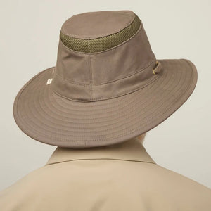 A man with a gray beard and mustache wears the TILLEY Airflo Hikers Hat T4MO-1 in olive, featuring UPF 50+ sun protection, and a beige button-up shirt, looking directly at the camera against a plain light background.