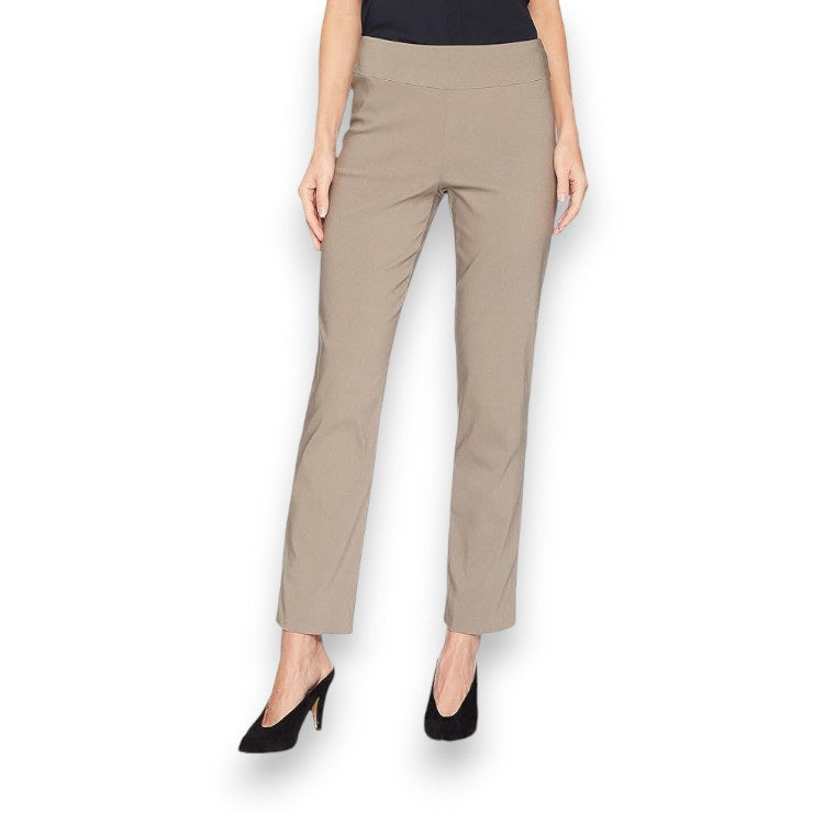 A person is wearing KRAZY LARRY, INC&#39;s PULL ON ANKLE PANT in a slim fit beige straight-leg style and black high-heeled shoes against a white background. The outfit is completed with a sleeveless black top that reveals part of the arms and torso.