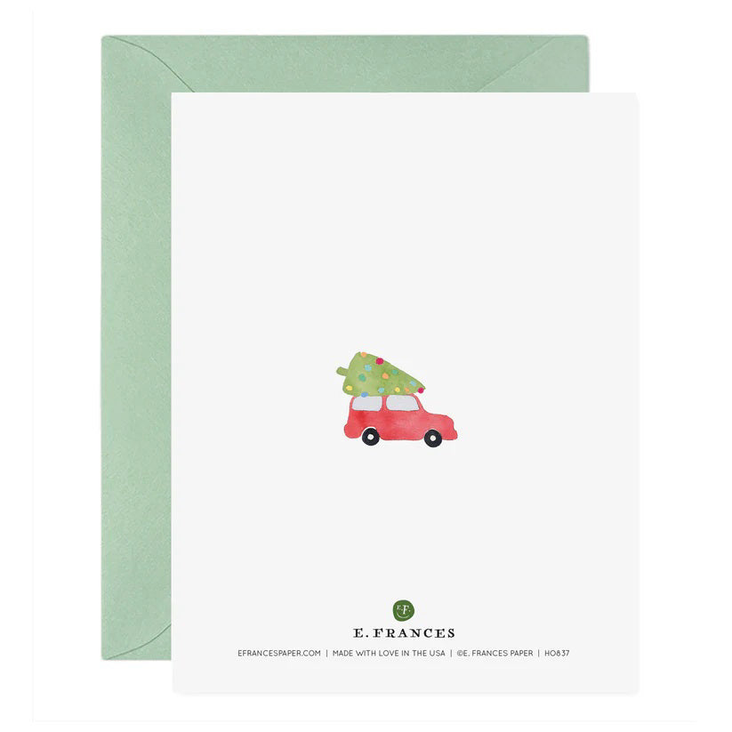 The FA LA LA LA LA TREES HOLIDAY CARD from E.FRANCES PAPER is a handcrafted watercolor greeting card featuring green trees and a small red car, with the phrase &quot;Fa la la la la&quot; among the foliage. Made in the USA, this festive Christmas card comes with a light green envelope, making it perfect for spreading holiday cheer.