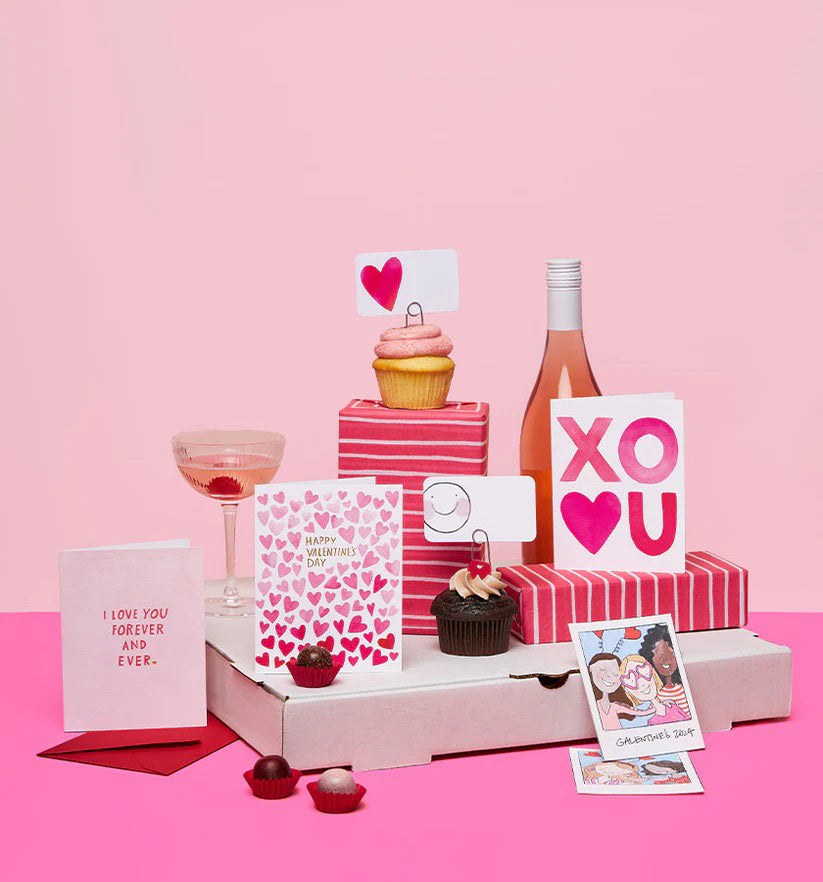 A clear box contains 85 tiny notecards each featuring a pink heart, labeled &quot;E. FRANCES PAPER - BIG HEART LITTLE NOTES.&quot; With the tagline &quot;use unsparingly,&quot; this minimalistic packaging enhances its unique charm.