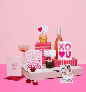 A clear box contains 85 tiny notecards each featuring a pink heart, labeled "E. FRANCES PAPER - BIG HEART LITTLE NOTES." With the tagline "use unsparingly," this minimalistic packaging enhances its unique charm.