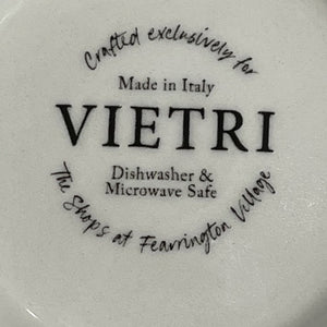 The FEARRINGTON SIGNATURE COLLECTION Beltie Oval Platter by VIETRI features black cow and calf silhouettes on green grass with blue clouds on a cream base, making it a charming gift inspired by Fearrington Village.