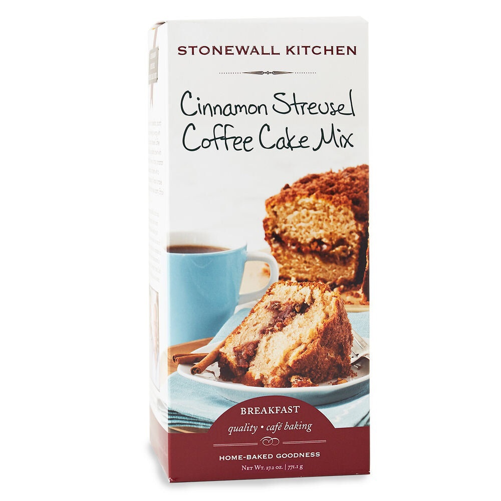 A rectangular box of STONEWALL KITCHEN - CINNAMON STREUSEL COFFEE CAKE MIX. The front features an image of a slice of coffee cake with crumb topping on a blue plate next to a blue coffee cup. Text on the box advertises &quot;quality + café baking&quot; and &quot;home-baked goodness.