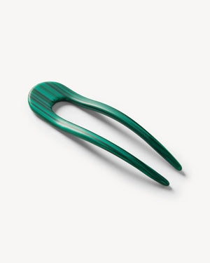 A smooth, black MACHETE - FRENCH HAIR PIN with two prongs, crafted from Italian acetate by MACHETE, rests on a plain white surface.