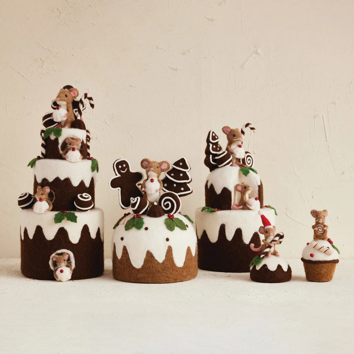 CREATIVE COOP HANDMADE FELT MOUSE ON CUPCAKE: Two styles—one mouse wears a Santa hat holding candy canes on a Christmas pudding, the other holds a swirl cookie on a cupcake with white icing and berries. Perfect for cake decorating.