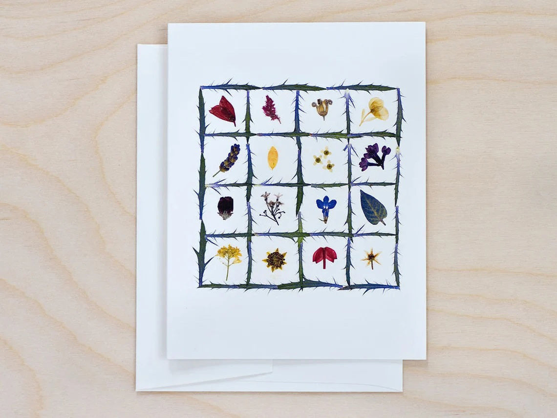 The PETAL PEOPLE PRESS - FLOWER QUILT CARD by PETAL PEOPLE PRESS features a grid of green stems filled with vibrant pressed flowers and leaves on a white background—a beautiful botanical design ideal for any blank notecard.
