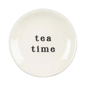Small, round cream-colored TEA TIME SMALL CERAMIC PLATE with “tea time” printed in black in the center.
