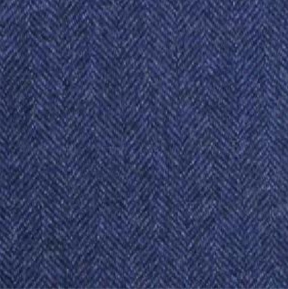 Close-up of the WIGENS Modern Wool Baseball Cap in Navy Herringbone, showcasing its textured blue fabric with a refined herringbone pattern—alternating diagonal lines create a chevron-like design, reflecting classic Italian textile heritage.