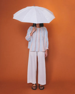 Introducing THE LITTLE PROJECT - CYRUS PANT IN PUCKERED STRIPE by THE LITTLE PROJECT, crafted from a luxurious Italian Rayon/Cotton blend with chic blue and white vertical stripes and an elastic waistband for ultimate comfort.