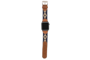 The LA MATERA CORBINA Apple Watch Band in Space Black features a rectangular screen and artisan-crafted brown leather strap with a black woven band adorned with tan diamond patterns, showcasing elegance on a crisp white background.