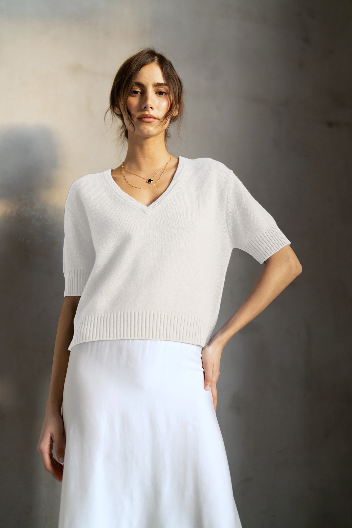 The ROSE &amp; CROWN Cashmere Short Sleeve V Neck Sweater in deep red is shown on a white hanger against a plain white background.