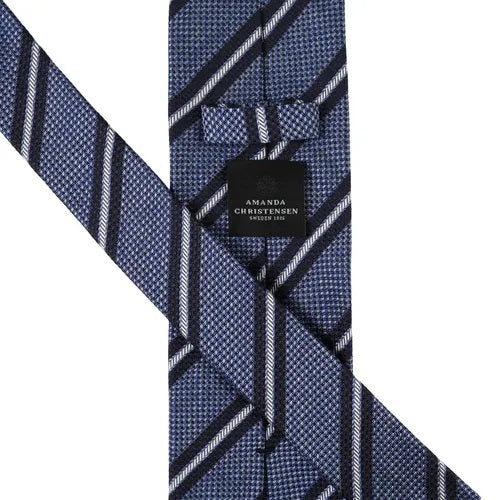 Introducing the AMANDA CHRISTENSEN - Striped Jacquard Woven Silk Tie in Sky Blue Melange: a refined addition to your men’s accessories collection, featuring a rolled-up jacquard woven silk design with an elegant textured pattern and diagonal white and dark blue stripes.