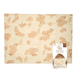 A baguette wrapped in the BEES WRAP- BEESWAX REUSABLE BREAD WRAP HONEYCOMB by BEES WRAP, filled with golden French fries and topped with two slices of bread and melted cheese, set against a white background.