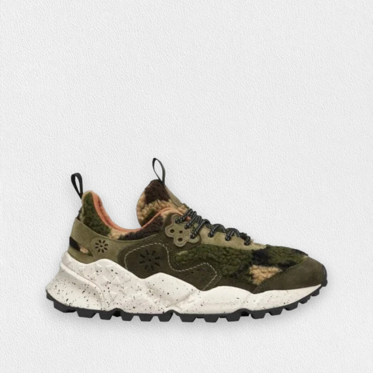 The FLOWER MOUNTAIN - KOKETSU SNEAKER by FLOWER MOUNTAIN/FALC USA features an olive-green teddy bear effect fabric upper, complemented by black laces on a white, speckled, ultra-lightweight rubber sole. The shoe includes a convenient loop at the heel, a distinctive flower-shaped accent near the laces, and is equipped with a rugged black outsole designed for optimal traction.