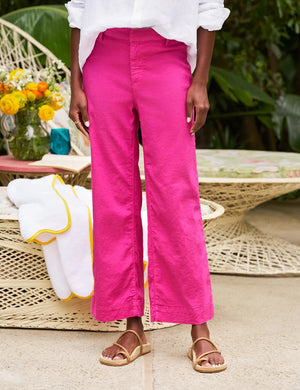 The FRANK & EILEEN Wexford Wide Leg Linen Pant in Guava features a bright pink hue, belt loops, and a concealed front closure, shown laid flat on a white background.