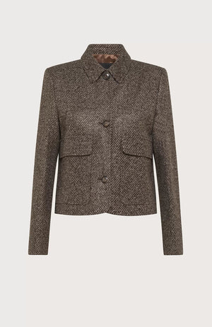 A brown, long-sleeved wool-blend jacket from SEVENTY, featuring a short length and micro pattern, is displayed on a white background. Made in Italy, it boasts a structured, boxy fit with a collar, two maxi flap pockets with buttons, and a button-down front closure. The SEVENTY jacket exudes a classic and sophisticated appearance.