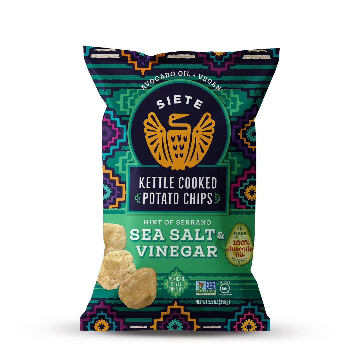 The image shows a bag of SIETE FOODS - KETTLE CHIPS SEA SALT VINAGAR WITH A HINT OF SERRANO. The packaging is adorned with vibrant patterns and highlights that the chips are made with 100% avocado oil, featuring zesty serrano peppers for an extra kick, and are vegan.