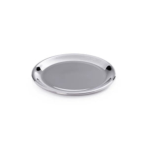 The ZODAX LOIRE WINE BOTTLE COASTER in a shiny nickel finish rests on wood, adding an elegant touch as it holds the base of a champagne bottle.