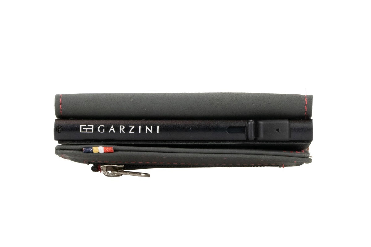 A closed GARZINI - SLIM TRIFOLD RFID-BLOCKING LEATHER WALLET WITH METAL CARD HOLDER AND COIN POCKET IN CARBON WITH RED sits beside a black "GARZINI" pen, both viewed from the side.