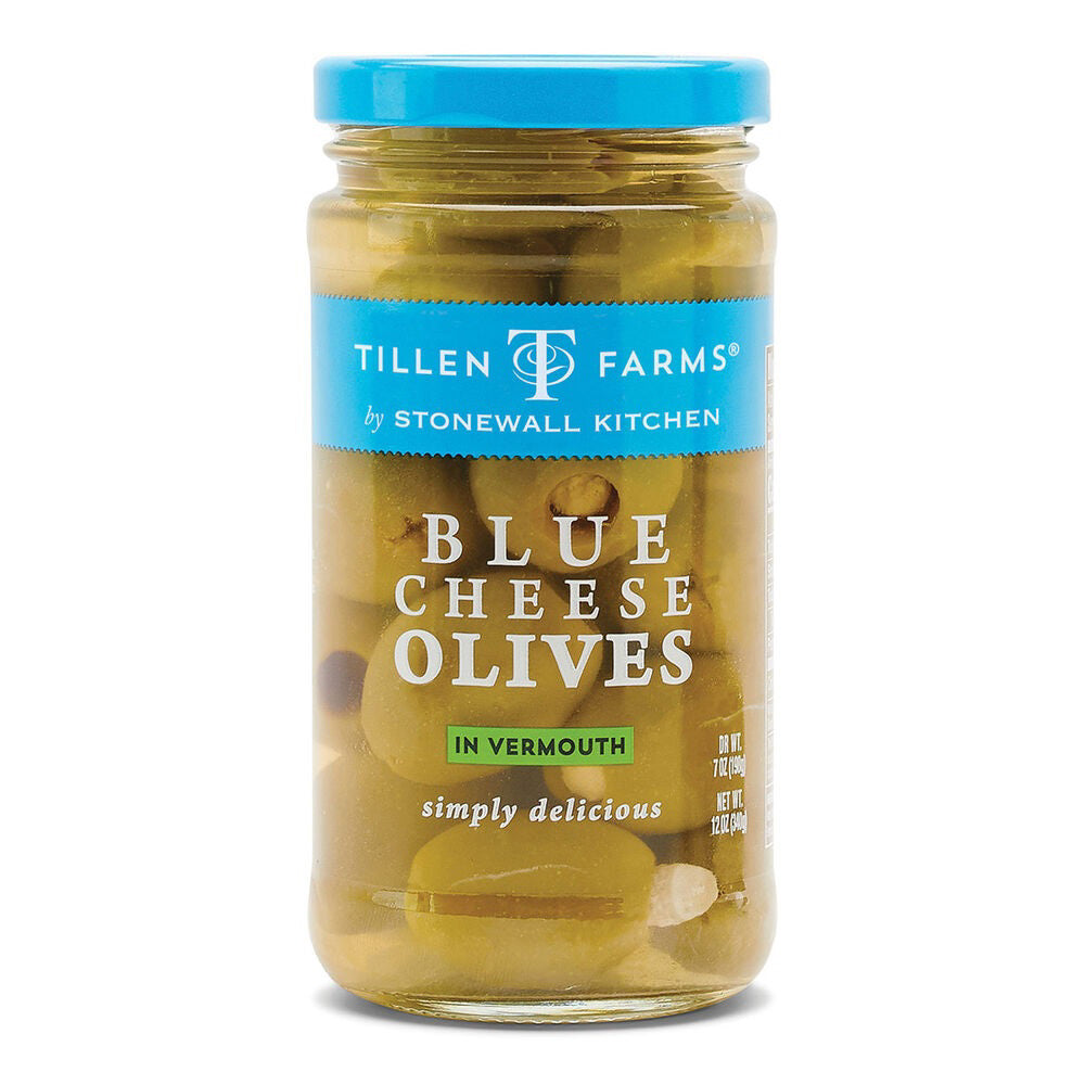 A jar of STONEWALL KITCHEN-BLUE CHEESE OLIVES, featuring a clear glass container with a blue lid. The label showcases green olives from the Halkidiki region stuffed with blue cheese and includes the phrases "simply delicious" and "10 fl oz (295 ml)".