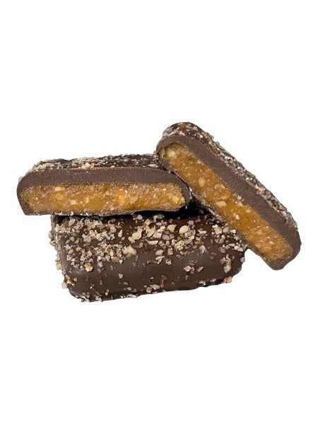 A blue box of GRIFF&#39;S TOFFEE - PECAN TOFFEE 7OZ, proudly labeled &quot;Gluten Free,&quot; features an image of dark chocolate pecan toffee pieces. With a net weight of 7 ounces (198.5 grams), this delicious treat from GRIFFS TOFFEE combines the richness of dark chocolate with the crunch of pecans for a delightful snack.