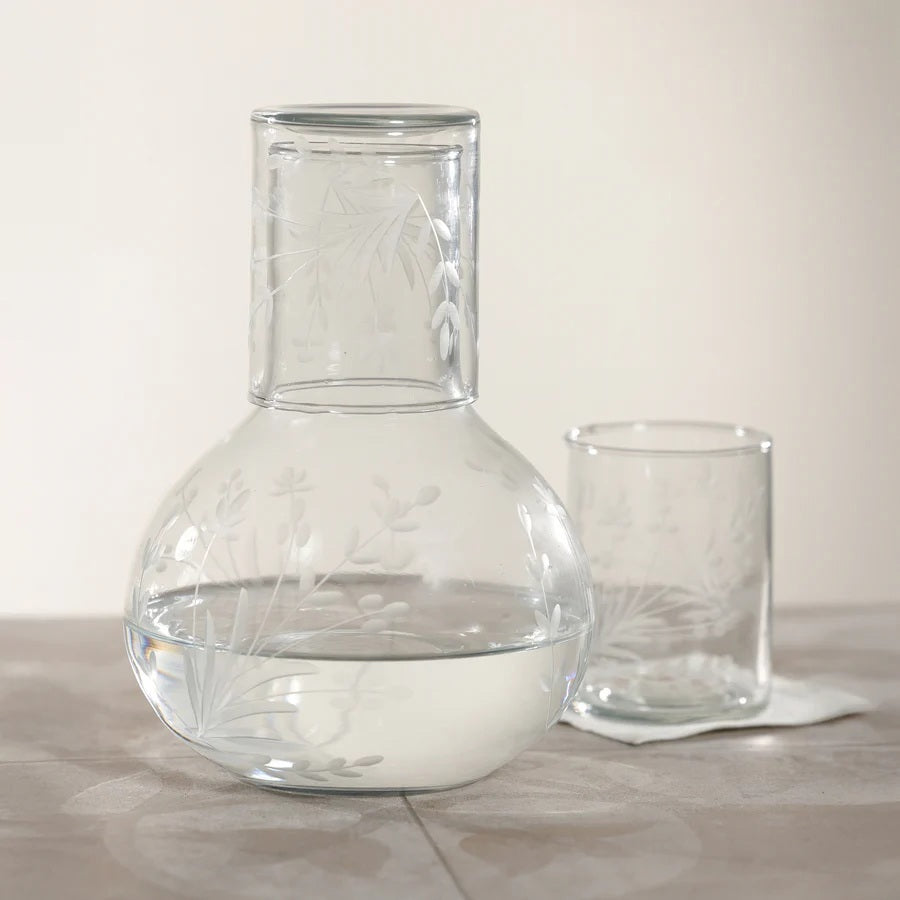 The ZODAX SHIRAZ TUMBLER features an etched flower design on its clear cylindrical surface, displayed against a plain white background.