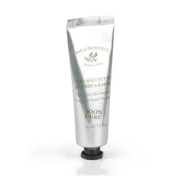A 30 ml (1 fl oz) metallic tube of SHEA BUTTER SKIN TREATMENT by EUROPEAN SOAPS, LLC. The silver tube with a black screw cap features text stating "Pure Shea Butter," "100% Pure," and "Dry Skin Treatment" in green and black. A logo with a bird is also visible, emphasizing its role as a natural moisturizer.