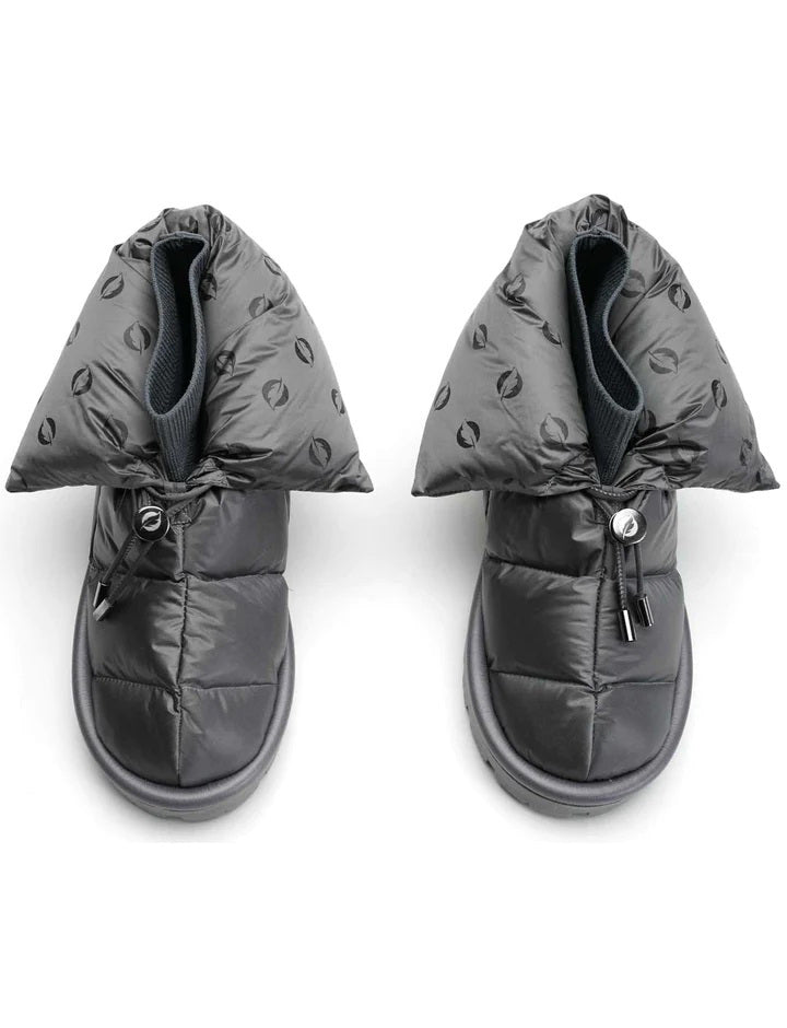 The METALLIC PILLOW BOOT by FLUFIE is a black, high-top winter boot with a padded, quilted design. It features a side zipper and a ridged sole, with the brand name "FLUFIE" embossed on the side of the sole. Insulated with goose down and boasting an anatomic insole, this boot is perfect for cold weather.