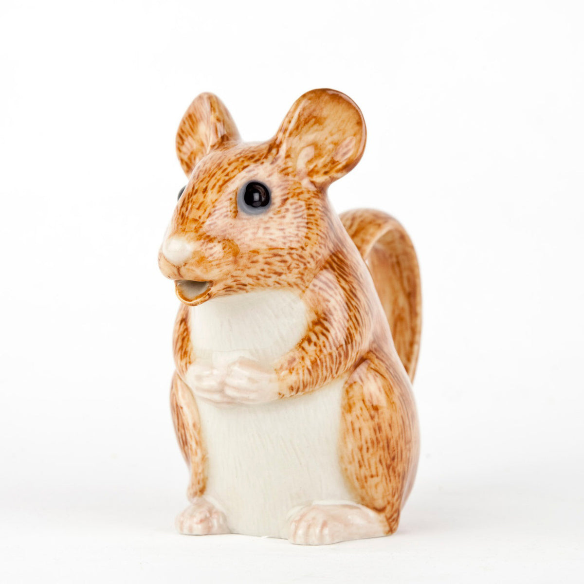 The QUAIL CERAMICS - WOOD MOUSE JUG by QUAIL DESIGNS is a hand-painted stoneware jug shaped like a seated brown mouse, featuring a textured, fur-like surface. Its handle forms the tail and the pour spout is at the mouth. Dishwasher safe, it sits against a plain white background.