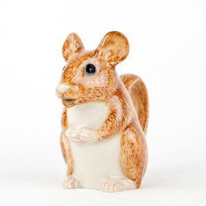 The QUAIL CERAMICS - WOOD MOUSE JUG by QUAIL DESIGNS is a hand-painted stoneware jug shaped like a seated brown mouse, featuring a textured, fur-like surface. Its handle forms the tail and the pour spout is at the mouth. Dishwasher safe, it sits against a plain white background.