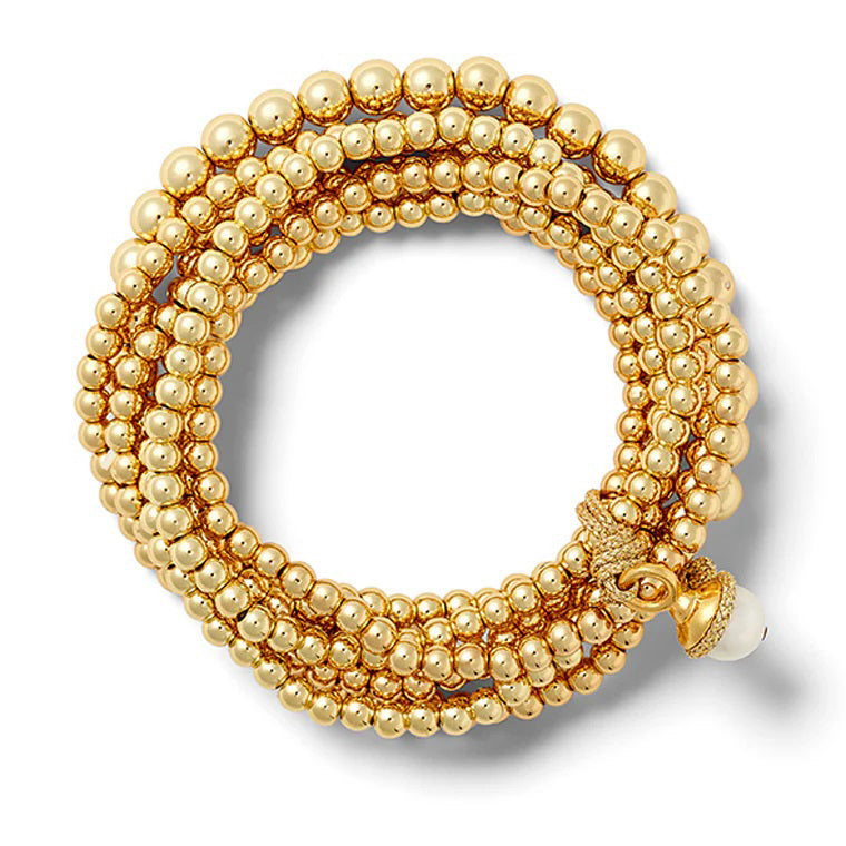 The Sally Bracelet by CC &amp; CO features multiple rows of shimmering 14 karat gold beads with an ornate clasp and a single white bead, forming an elegant circular pattern against a white background.