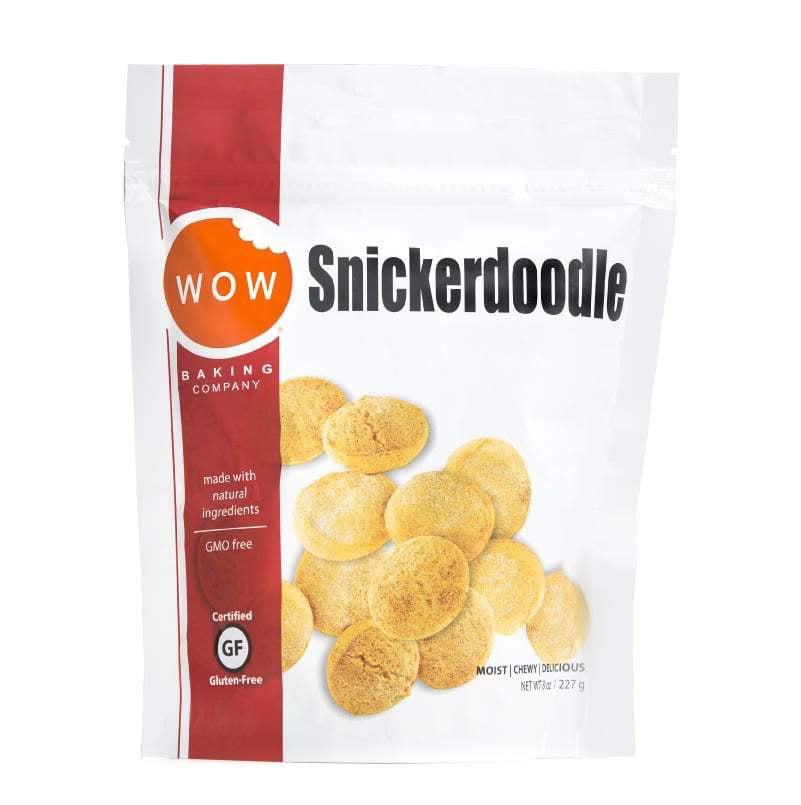 A white bag of WOW Baking Company's Gluten-Free Snickerdoodle Cookie Pouch against a white background. The bag features an image of soft and chewy cookies with text indicating the cinnamon and sugar treats are GMO-free, made with natural ingredients, and certified gluten-free. Net weight is 227 grams.