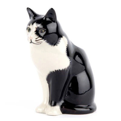 The QUAIL CERAMICS - BARNEY BUD VASE by QUAIL DESIGNS is a hand-painted black and white ceramic cat vase, shown with pink, white, and purple flowers including lavender, set against a plain white background.