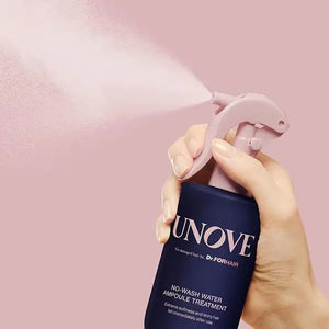 The "UNOVE - NO WASH WATER AMPOULE HAIR TREATMENT" by EXOD INTERNATIONAL, in a dark blue bottle with a pink nozzle, provides instant hydration and shine for your hair with no rinsing required.