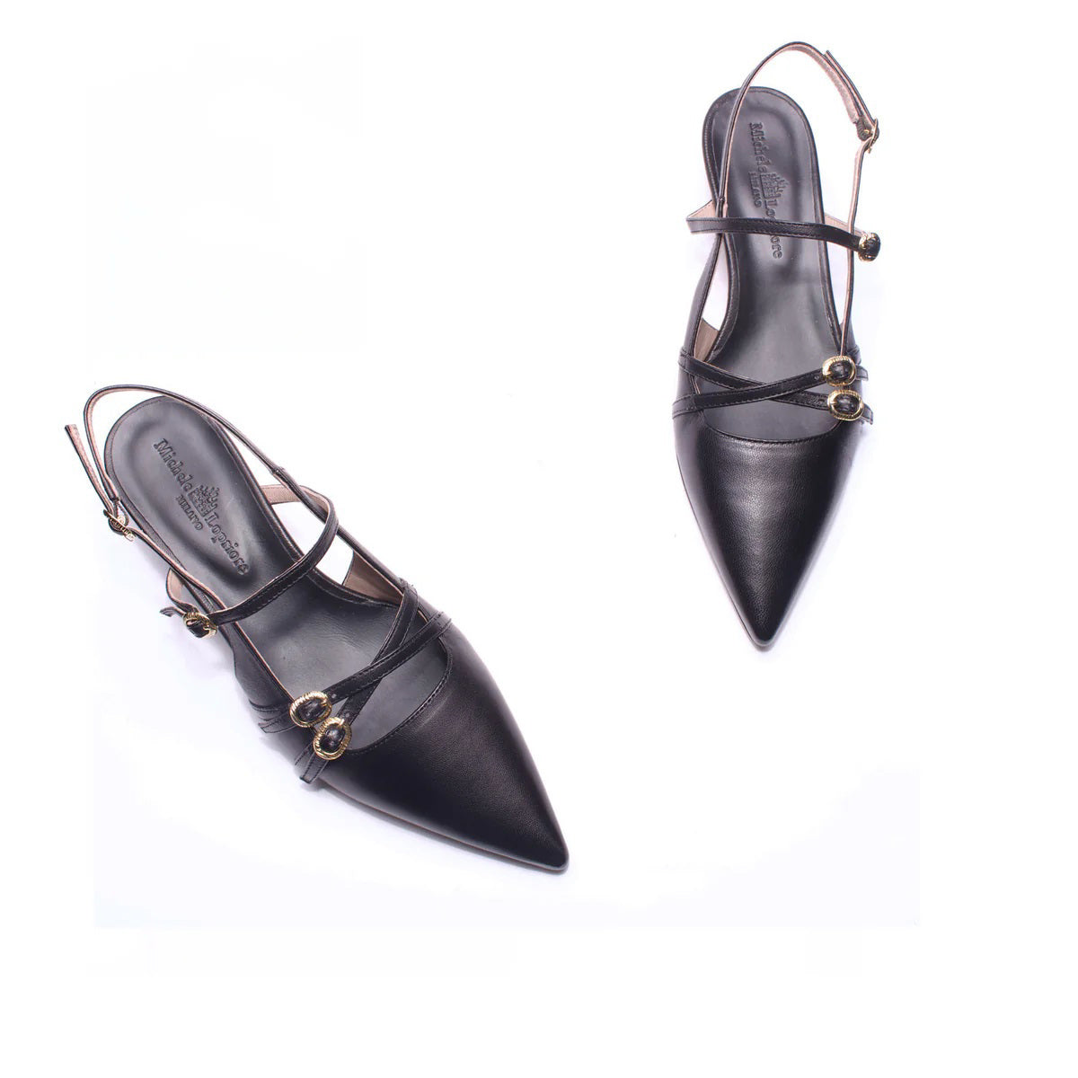 The MICHELE LOPRIORE - LUCILLE KITTEN HEEL is a sleek, modern slingback with a white pointed toe and low kitten heel. It features two buckled straps on a plain white background.